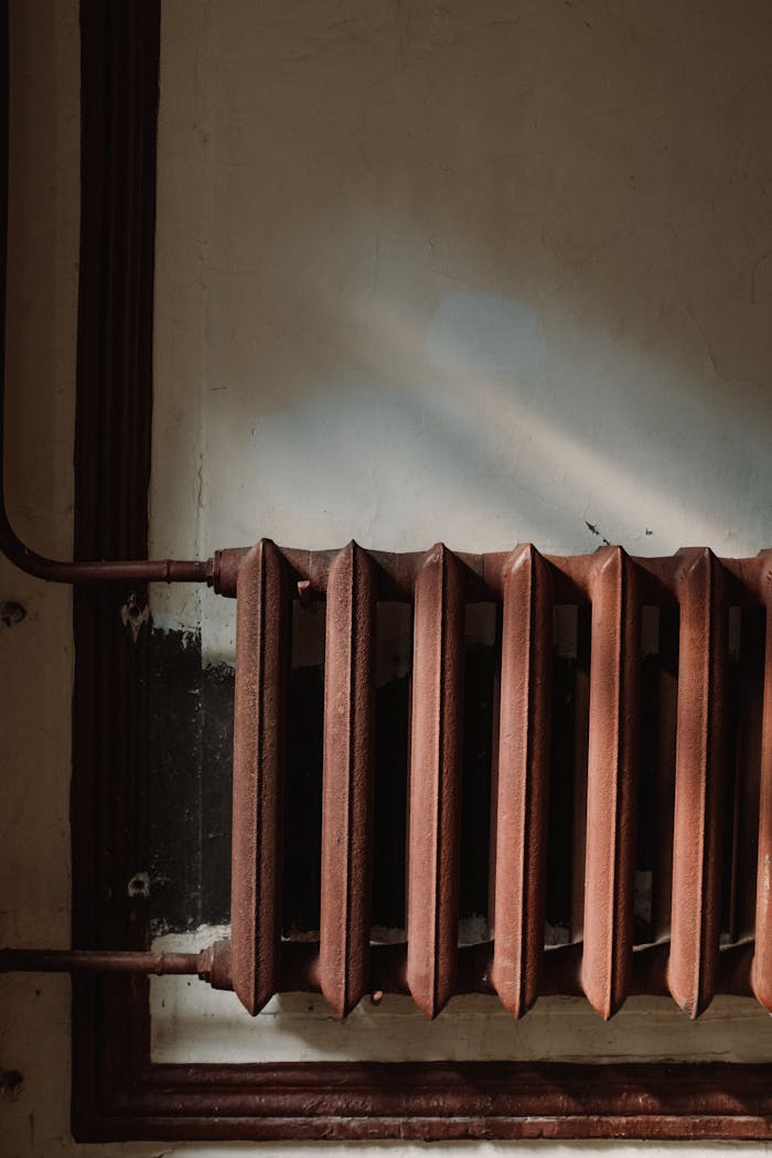Rusty Steam Radiator on Wall 